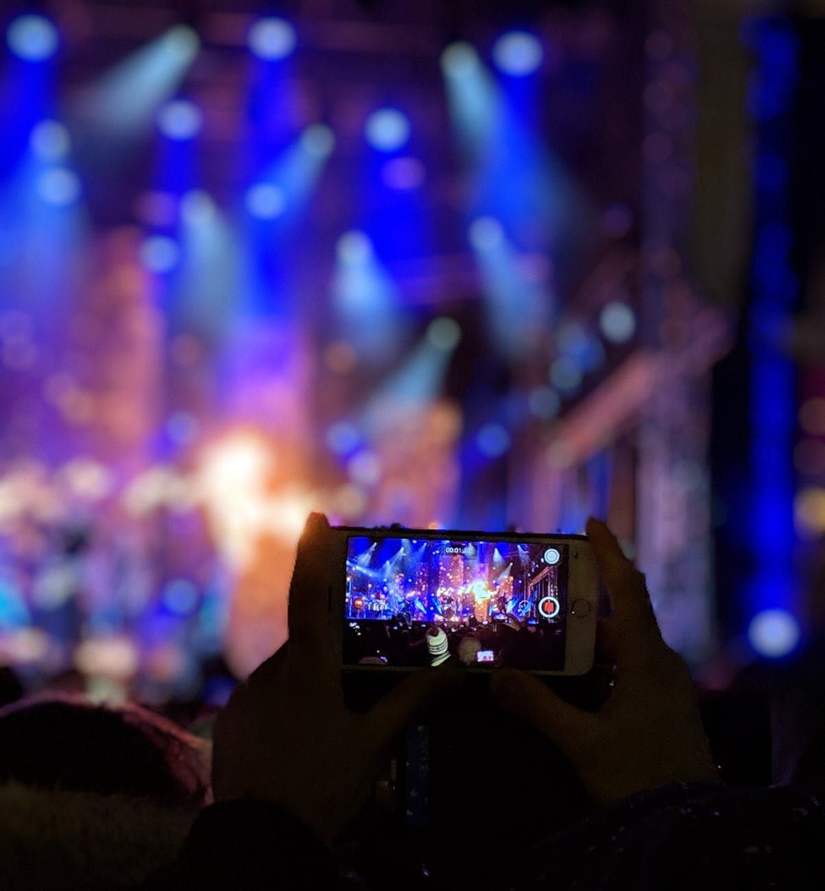 Fã usa telefone celular para grava vídeo em show