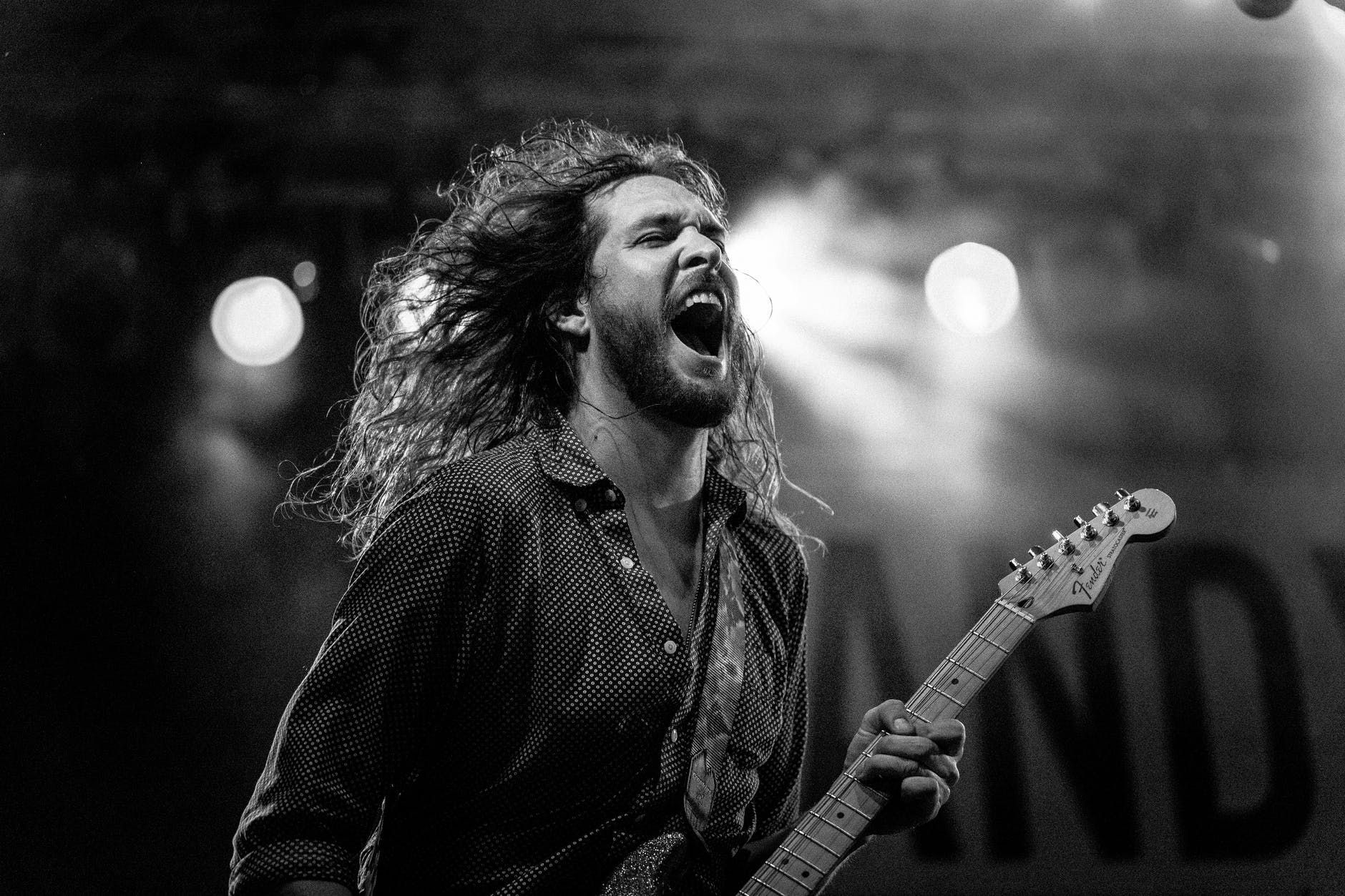 Guitarrista de cabelo grande faz solo de rock